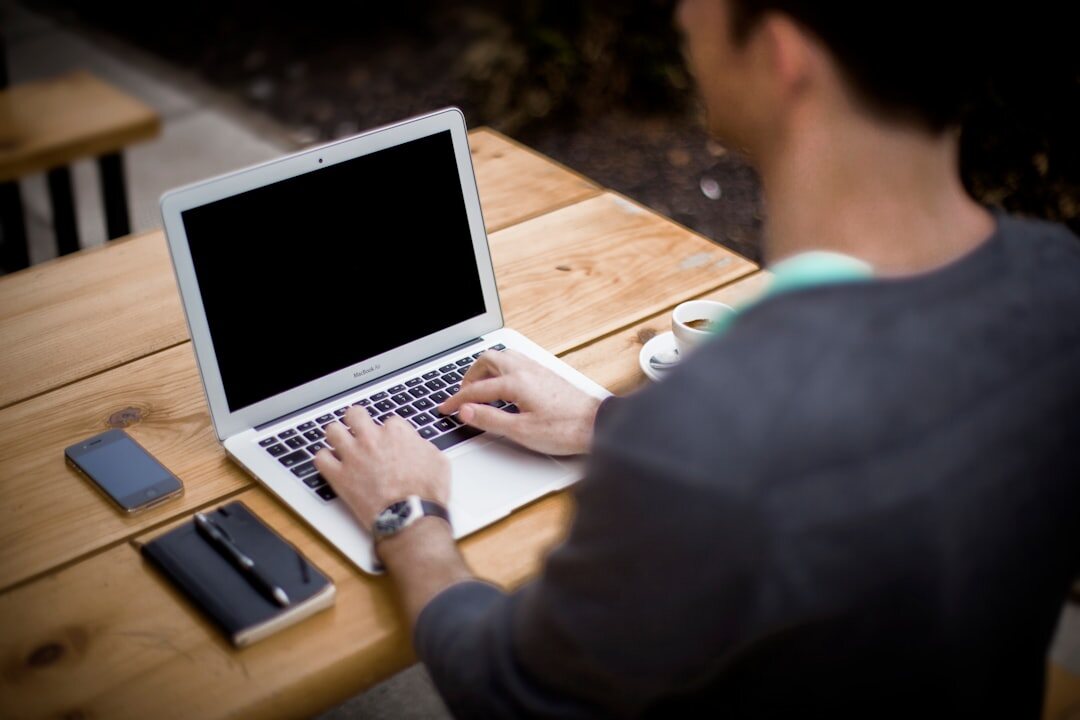 author typing on laptop